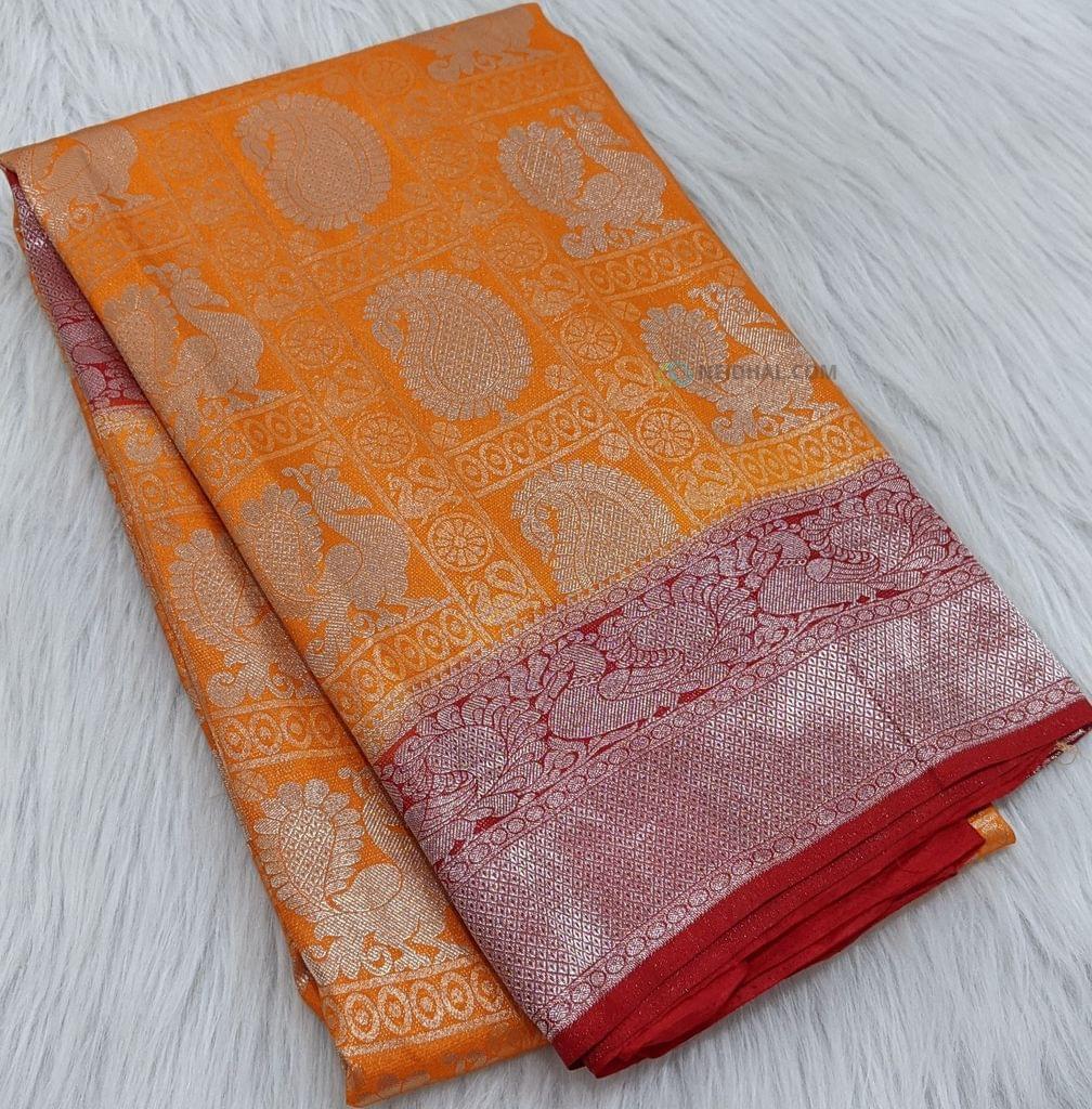 CODE WS279 : Light orange soft brocade saree with silver zari woven design all-over, contrast red borders , rich silver zari woven pallu and plain running blouse with borders